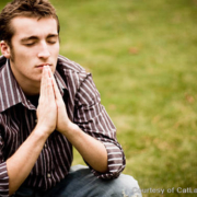 Teenager with hands in prayer